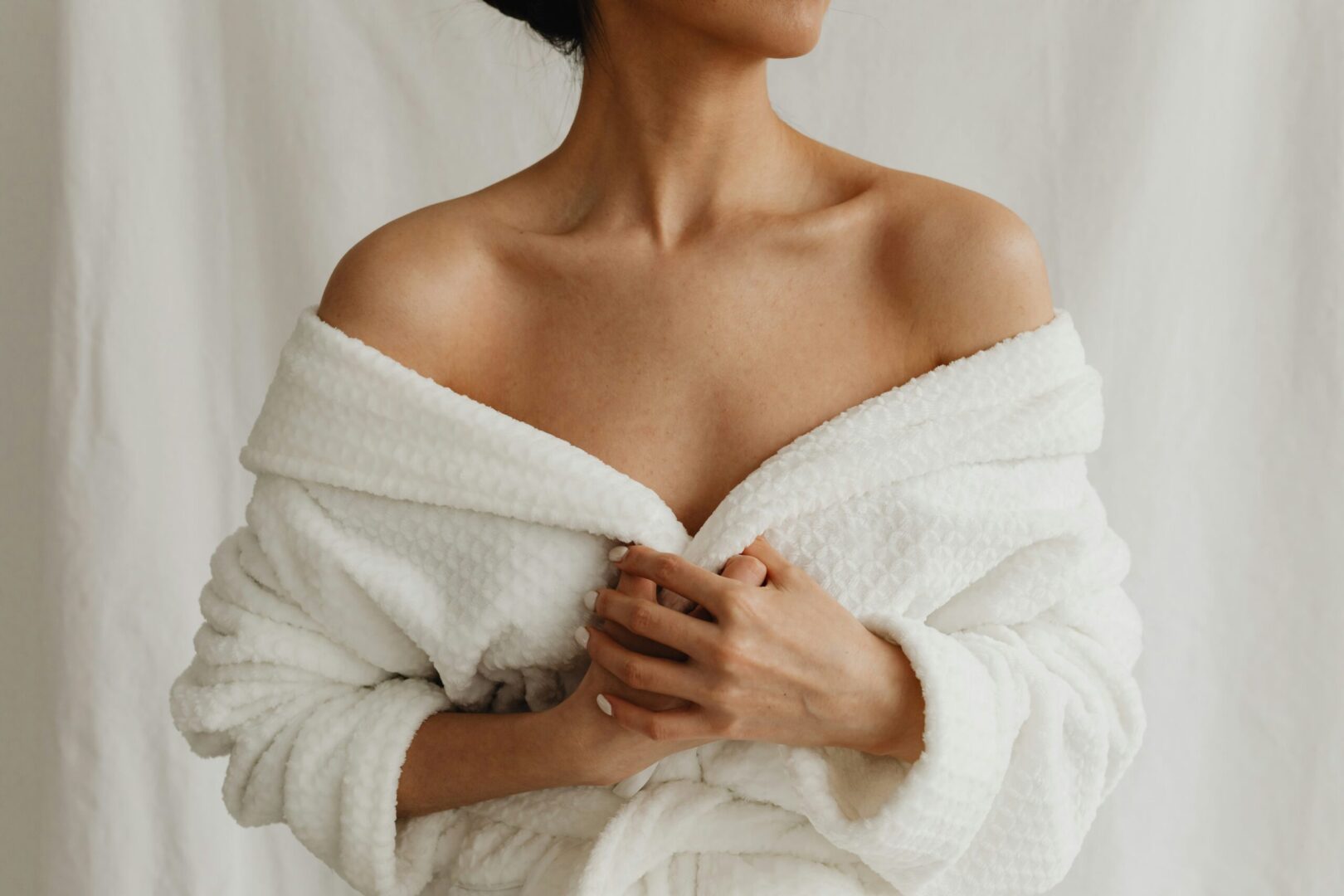 Woman in a robe, relaxing and enjoying a spa treatment