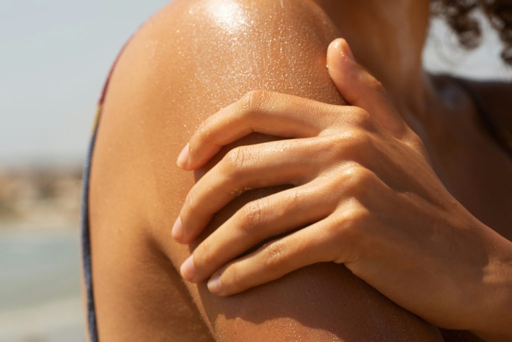 Woman’s shoulder with a natural, sun-kissed tan
